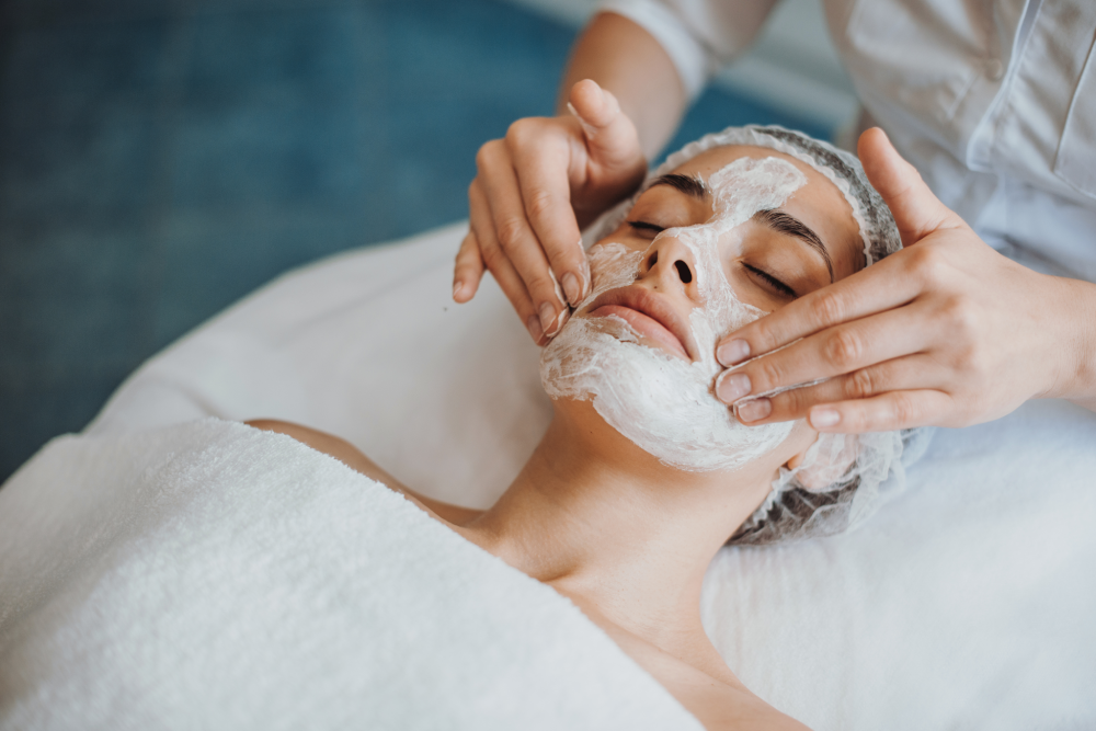 A relaxing medspa session with a facial mask applied.